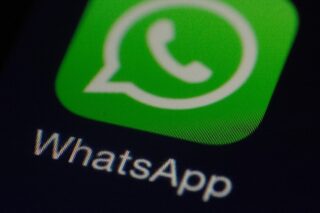 Nahaufnahme des WhatsApp-Logos auf einem Smartphone-Bildschirm. Das Logo zeigt ein grünes Quadrat mit einer Sprechblase und einem Telefonhörer in Weiß.